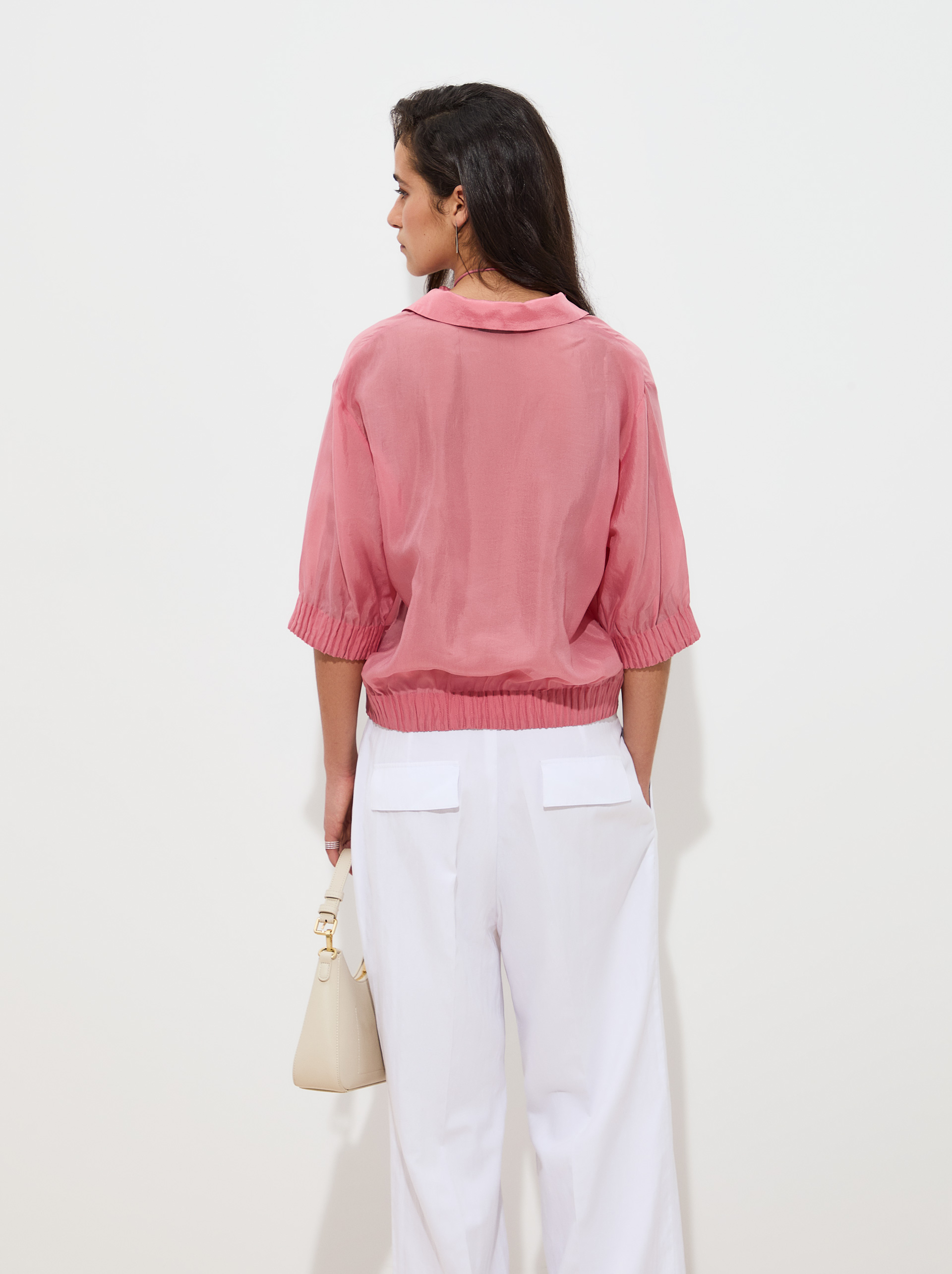 Flowy cupro blouse with flower detail.