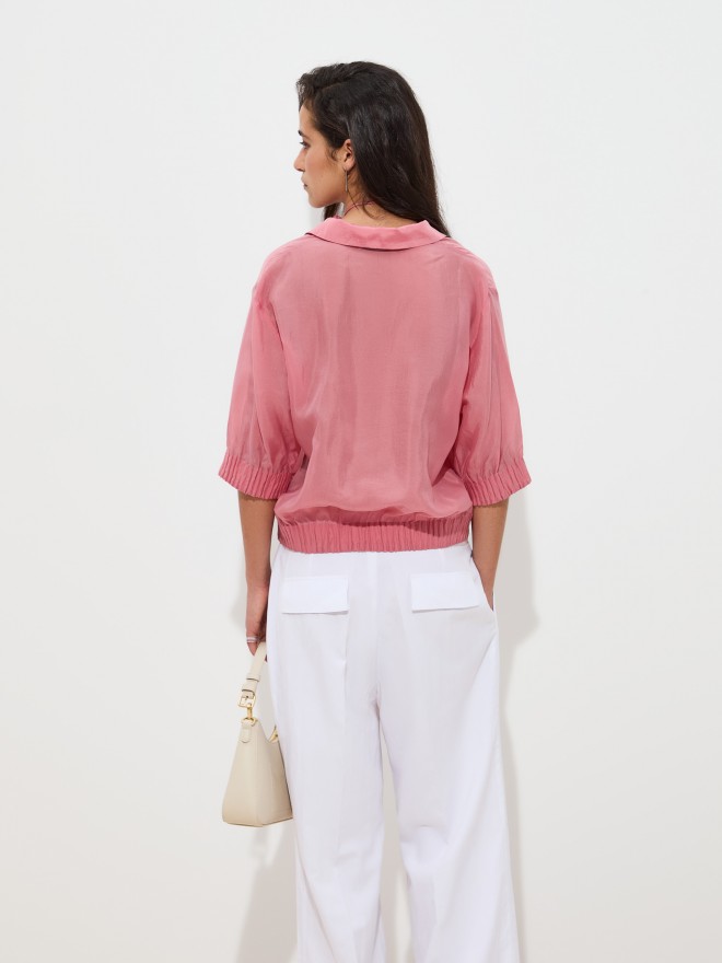 Flowy cupro blouse with flower detail. Flowy cupro blouse with flower detail.